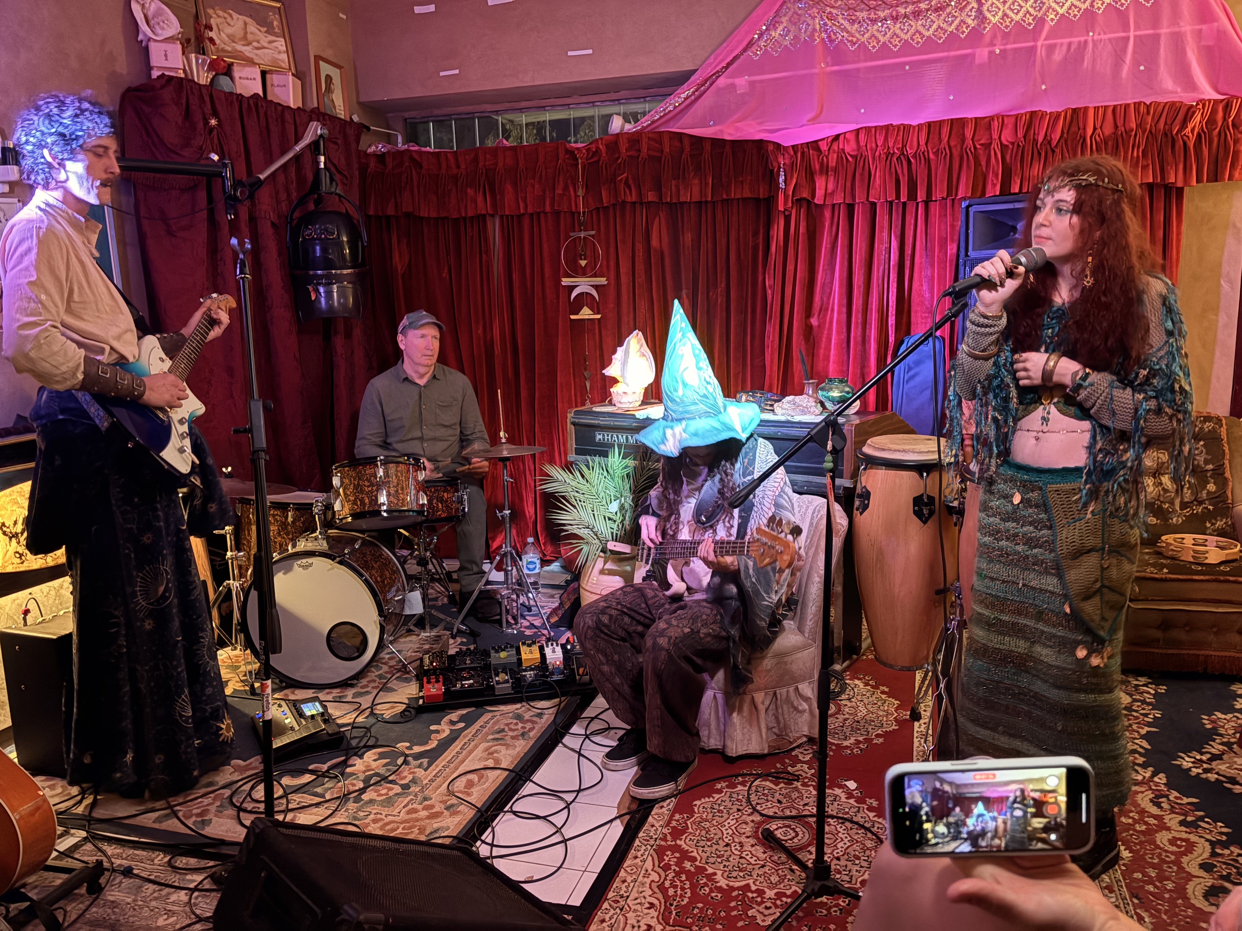 Band in full flight with singer and wizard hat