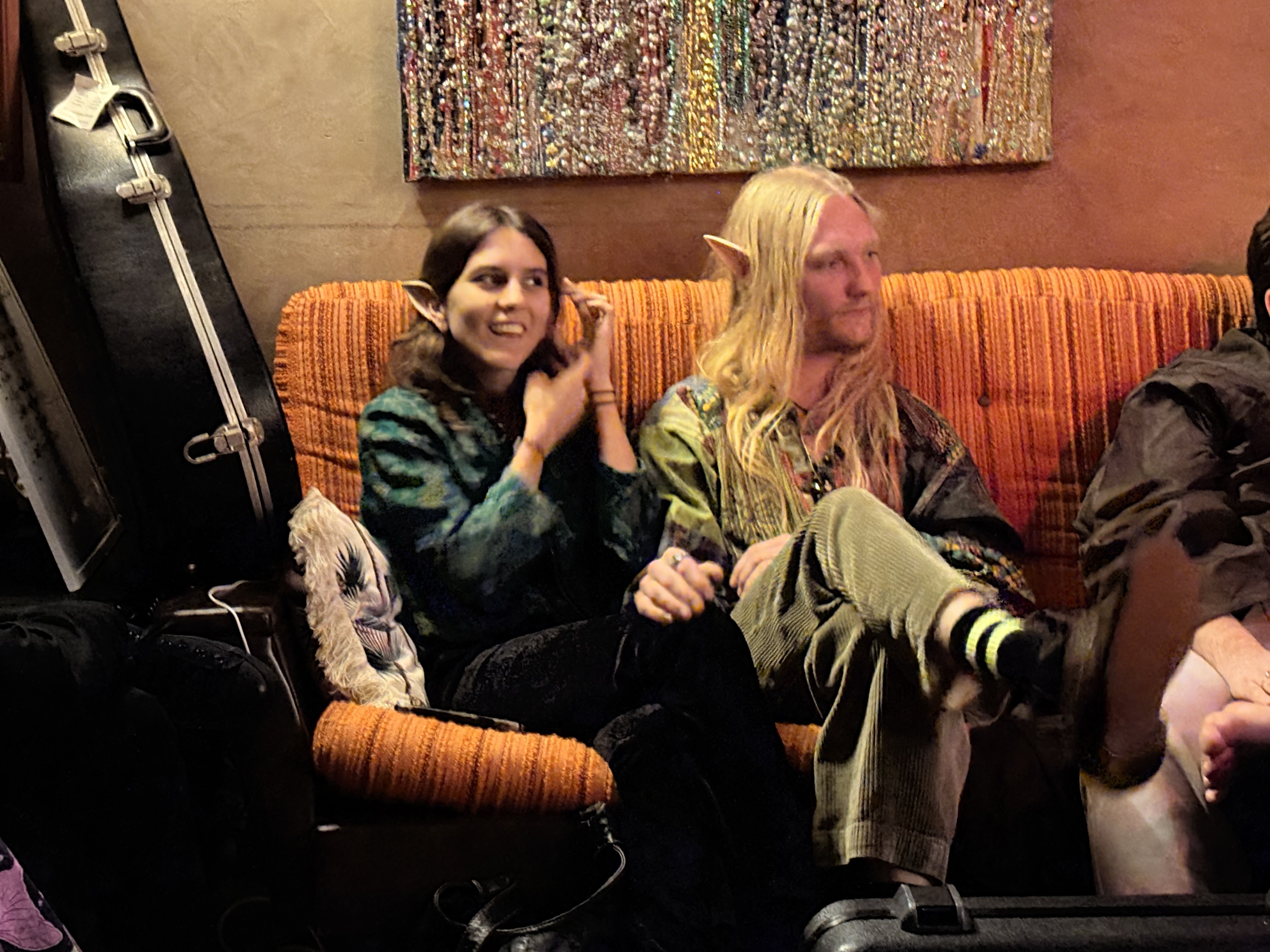 Guests with elf ears on the orange couch