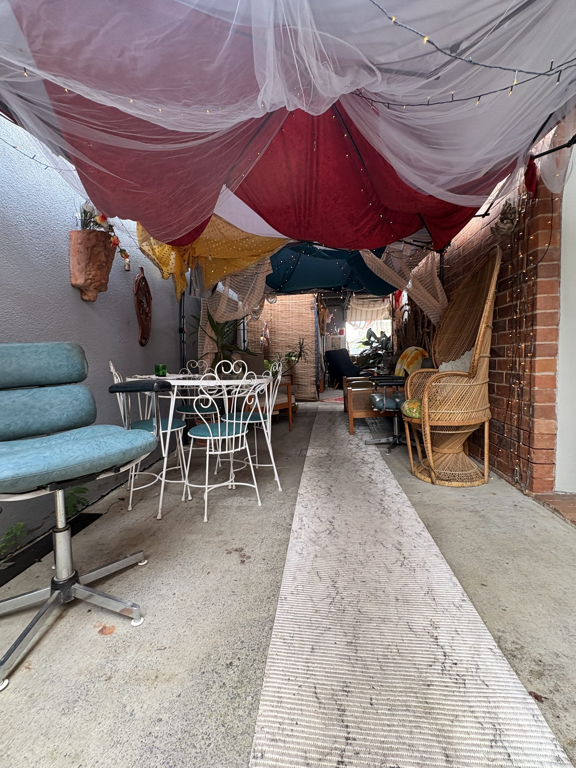 Fairy-lit laneway with café seating at Joy's on the Avenue